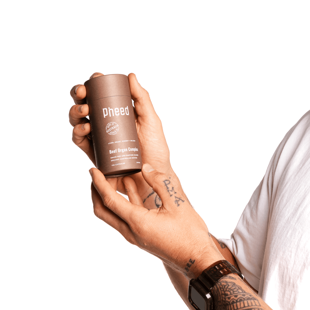 Man holding freeze dried organic Australian beef organ capsules product on white background