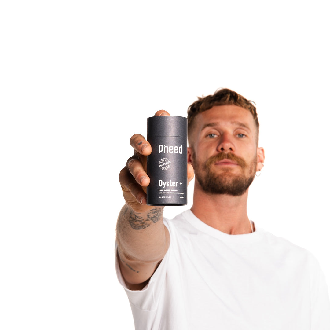 Man presenting Pheed Oyster+ Australian oyster extract capsules.