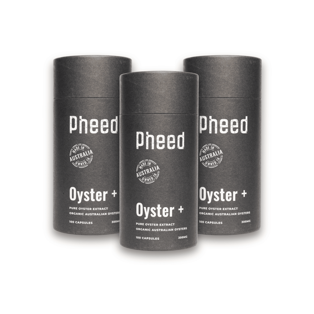 Three cylindrical containers of oyster capsules labeled 'Pheed Oyster+' on a white background