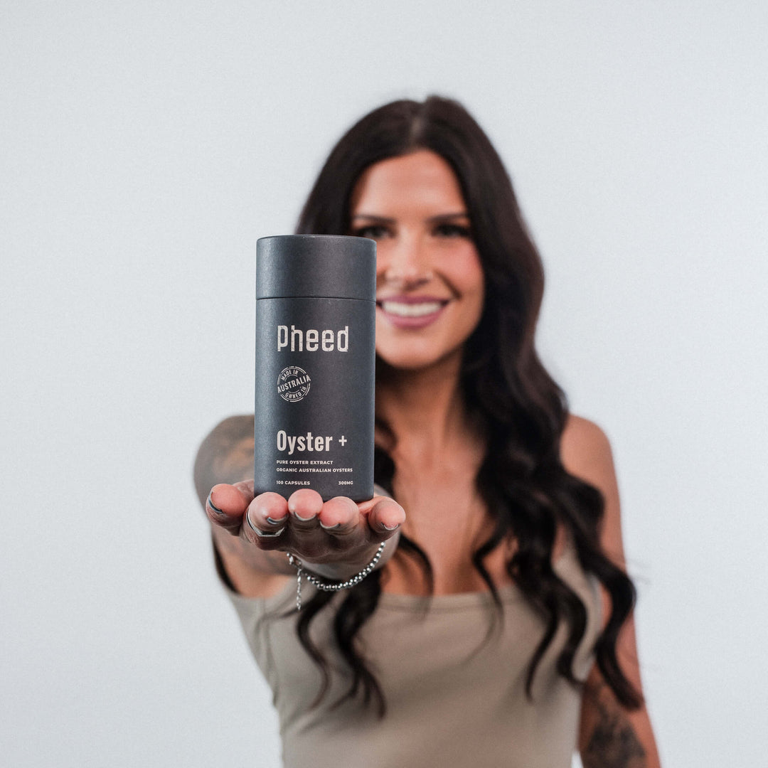 Woman holding a container labeled 'Pheed Oyster' against a plain background