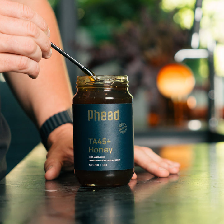 TA45+ Jarrah Honey from Western Australia with man holding a spoon