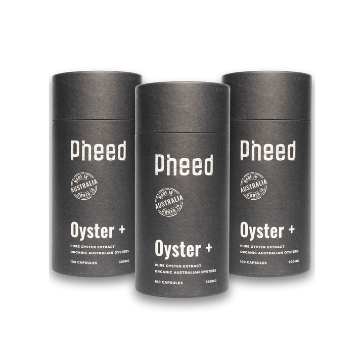 Three oyster capsule cylindrical containers labeled 'pheed' on a white background