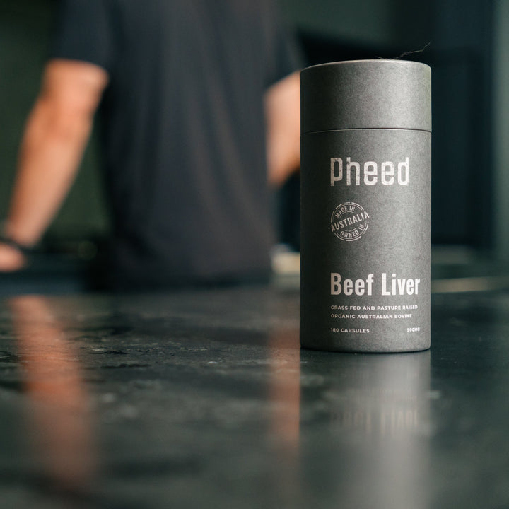 Beef Liver capsules sitting on kitchen bench with man in background