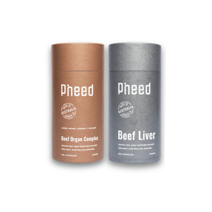 Two cylindrical containers with beef organ capsules and beef liver capsules labeled 'Pheed' on a white background
