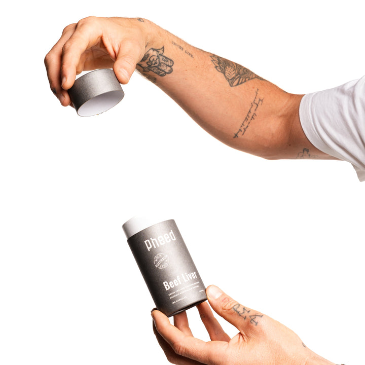 Man holding Beef Liver capsules with lid off on white background