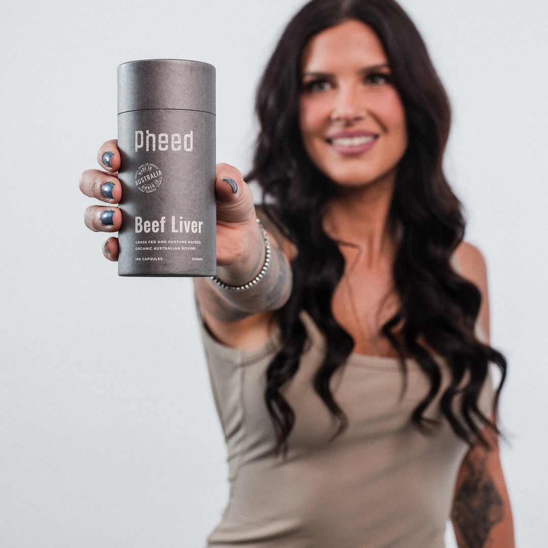 Woman holding a container labeled 'Pheed Beef Liver' against a plain background