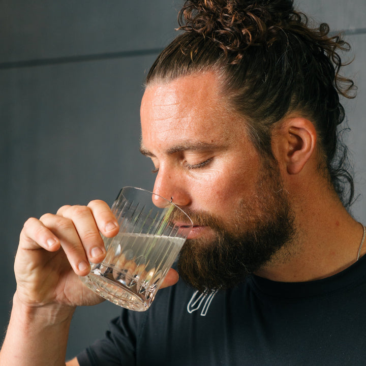 Man drinking from cup of hydrolysed collagen powder mixed in water