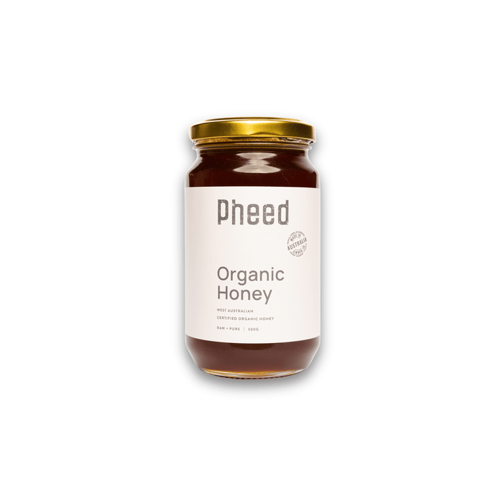Jar of Pheed Organic Honey on a white background