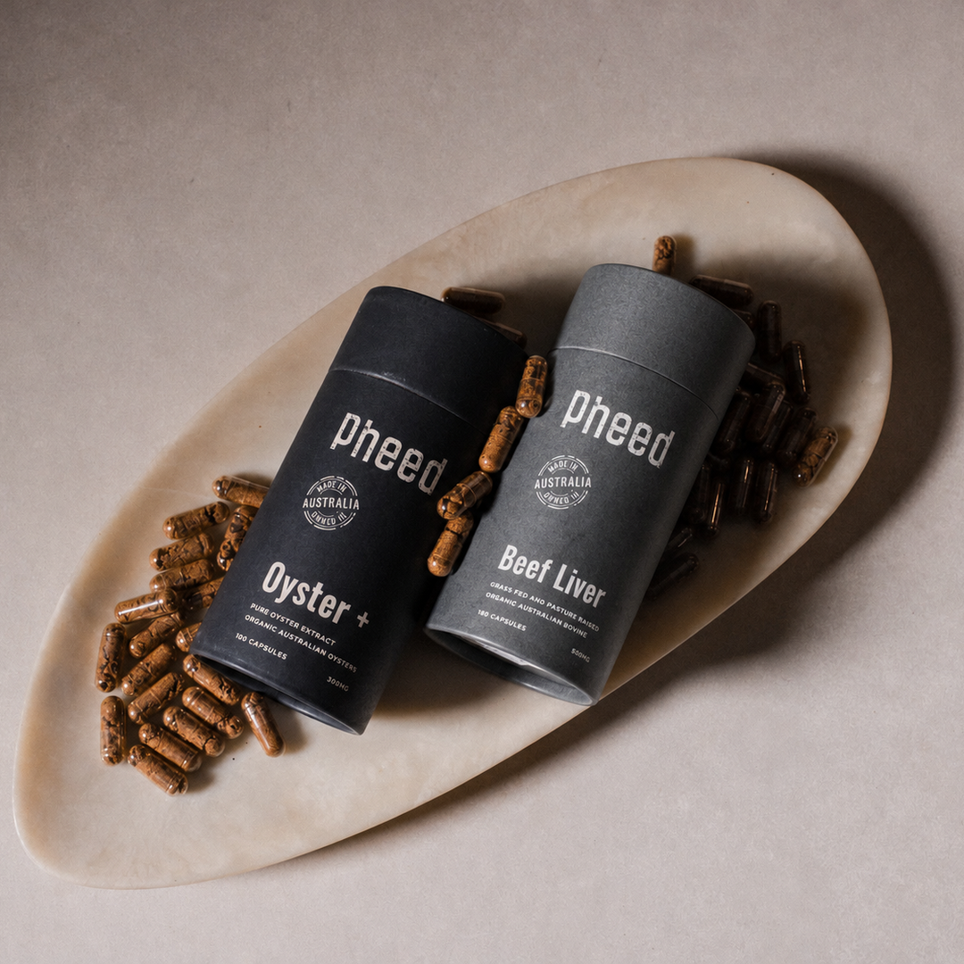 Two 'Pheed' containers on a plate with capsules around them.